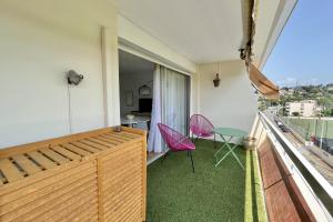 a room with a balcony with a table and chairs at Bright studio just outside Cannes in Le Cannet