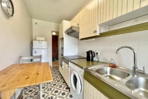 a kitchen with a sink and a washing machine at Bright studio just outside Cannes in Le Cannet