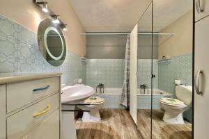 a bathroom with a sink and a toilet and a shower at Bright studio just outside Cannes in Le Cannet +2 photos