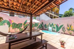 an outdoor patio with a table and a pool at D'Ajuda Inn in Arraial d'Ajuda
