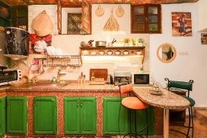 a kitchen with green cabinets and a counter top at Dar Houda in Fez