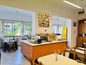 a kitchen and dining room with tables and chairs at Hotel Verbena in Lido di Camaiore