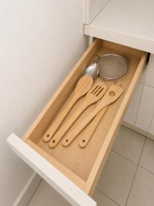 a wooden cutting board with utensils in a kitchen at Comfortable Stay O in Hollywood +13 photos