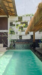 a swimming pool in front of a building at Dayunan in Bacolod