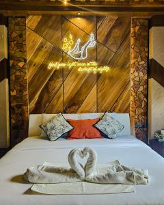 a bed with two swans in the shape of a heart at Dayunan in Bacolod