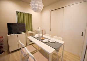 a dining room with a white table and chairs at WAMARE Shibamata, Entire private two-story house, Traditional Tokyo Stay with Easy Access to Haneda & Narita Airports, up to 4pax in Tokyo