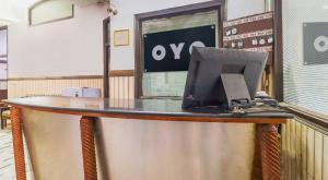 a desk with a laptop computer on top of it at Hotel O Prem Chunaria in Morādābād