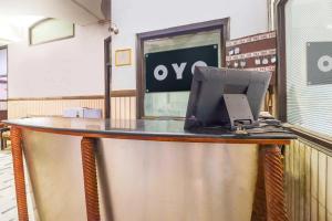 a counter with a laptop computer on top of it at Hotel O Prem Chunaria in Morādābād