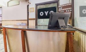 a counter with a laptop computer on top of it at Hotel O Prem Chunaria in Morādābād