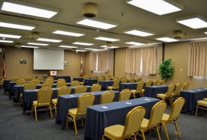 a conference room with blue tables and yellow chairs at Sands Inn & Suites in San Luis Obispo +36 photos