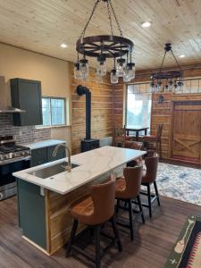 a kitchen with a large island with a sink at Rustic Bay View Cabins- Lodge in Homer