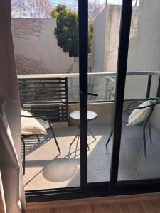 a view of a balcony with a table and chairs at Hermoso departamento Saavedra 4741 in Buenos Aires