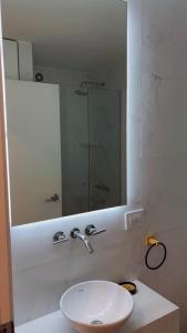 a bathroom with a white sink and a mirror at Hermoso departamento Saavedra 4741 in Buenos Aires +7 photos