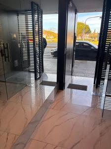 a car is parked outside of a revolving door at Hermoso departamento Saavedra 4741 in Buenos Aires