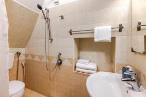a bathroom with a shower and a sink and a toilet at Vitti Stone House - Centro Storico Castellana in Castellana Grotte +14 photos