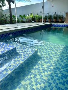 a swimming pool with blue tiles in the water at Evergreen Private Pool Villa - Cavite in General Trias +7 photos
