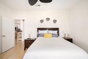 a bedroom with a bed with a yellow pillow on it at Beachfront Fire Pit Gourmet Kitchen Views in Bolivar Peninsula +74 photos