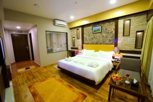 a hotel room with a bed and a living room at Hotel Queens Park in Pokhara +131 photos
