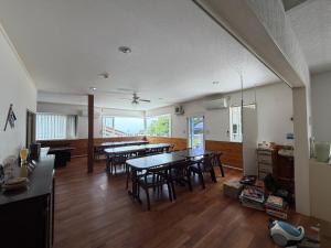 a dining room with tables and chairs in a room at Villa Knossos in Higashiizu
