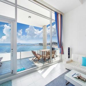 a living room with a view of the ocean at Vinolian Ocean View Spa Pension in Goseong