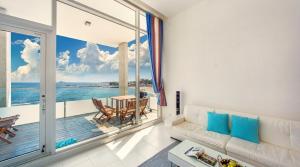 a living room with a view of the ocean at Vinolian Ocean View Spa Pension in Goseong +10 photos