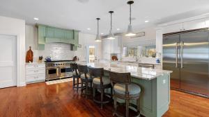 a kitchen with a large island with bar stools at Welahpu Beach in Cape May