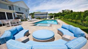 a patio with blue furniture and a swimming pool at Welahpu Beach in Cape May