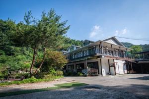a large house with a balcony on top of it at Gapyeong Solgogae Pension in Gapyeong
