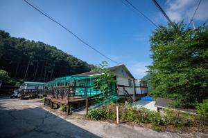 a row of houses with green roofs at Gapyeong Solgogae Pension in Gapyeong