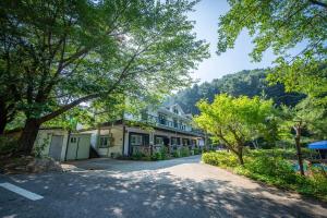 a home in the mountains with a driveway at Gapyeong Solgogae Pension in Gapyeong +12 photos