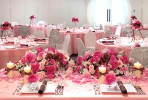 a group of tables with pink flowers on them at Grand Plaza Nakatsu Hotel in Nakatsu