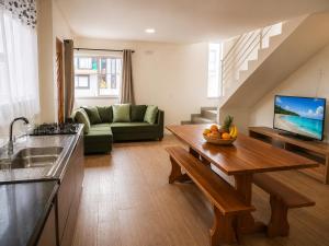 a living room with a couch and a table at Sobrado do Papagaio in Palhoça
