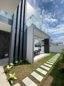 a house with a balcony with a chair on it at Villa 49 in Abidjan