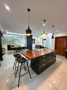 a large kitchen with a large wooden table and chairs at Villa 49 in Abidjan