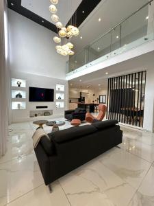 a living room with a black couch and a table at Villa 49 in Abidjan