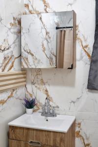 a bathroom with a sink and a mirror at The Cozy Beach Studio in San Juan +12 photos