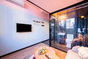 a living room with a tv and a table at Beijing xiyou hotel in Beijing