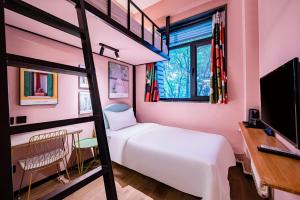 a bedroom with a bunk bed and a desk at Beijing xiyou hotel in Beijing