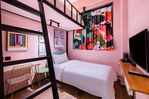 a bedroom with a bunk bed and a desk at Beijing xiyou hotel in Beijing