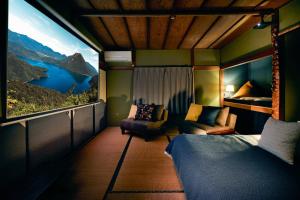 a room with a bed and a view of a mountain at Nikko Botan - 3 Min Walk from JR Nikko Station in Nikko