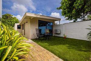 a backyard with a table and a fence at Esensia Boutique Studio in Oranjestad