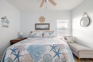 a bedroom with a bed and a chair at Gulf Views Steps to Beach 2 King Beds 3Bd 2Bth in Bolivar Peninsula