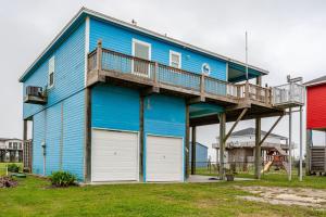 a blue house with a deck on top of it at Gulf Views Steps to Beach 2 King Beds 3Bd 2Bth in Bolivar Peninsula