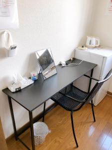 a black desk with a chair next to a sewing machine at HOSTEL198 Private Room of Third floorーVacation STAY68050v in Osaka