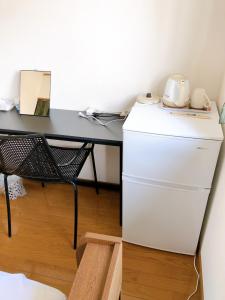 a desk with a refrigerator and a table with a toaster at HOSTEL198 Private Room of Third floorーVacation STAY68050v in Osaka