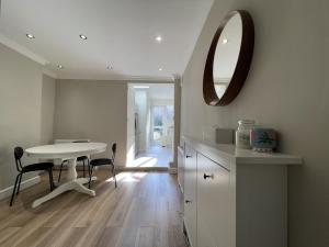 a kitchen with a table and a mirror on the wall at Full House - Croydon centre in Croydon