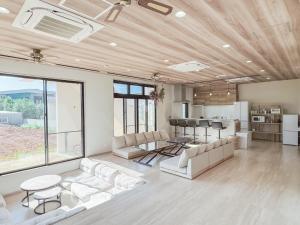 a living room with a couch and a table at guest house ALO in Miyako-jima