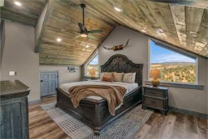 a bedroom with a large bed and a large window at Sandstone Pointe, Elegance Among the Cliffs in Mount Carmel +63 photos
