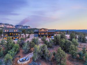 an aerial view of a house with mountains in the background at Sandstone Pointe, Elegance Among the Cliffs in Mount Carmel