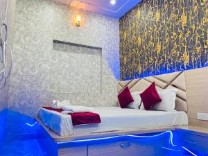a bedroom with a large bed with red pillows at Hotel Maatrika and banquets in Orchha